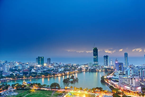 Colombo’s illuminated skyline and waterfront beneath a deep blue evening sky